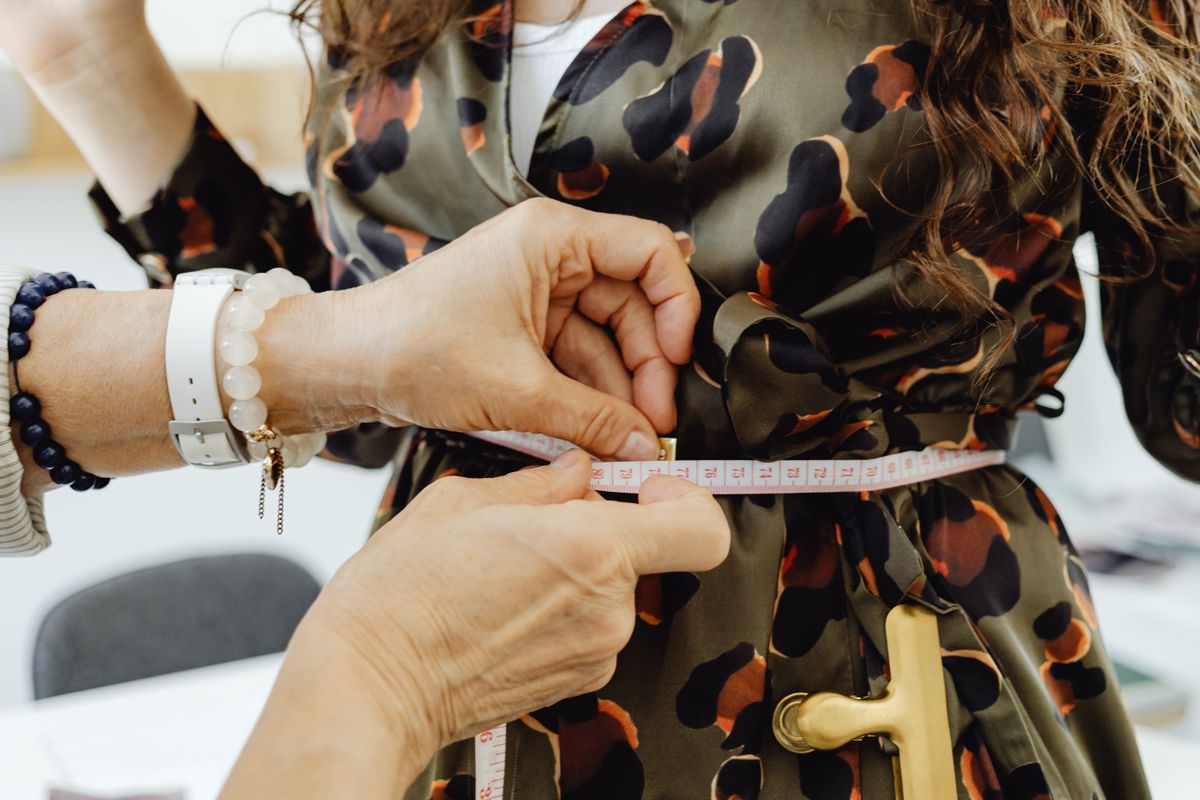 Fitting measurement being taken on a dress