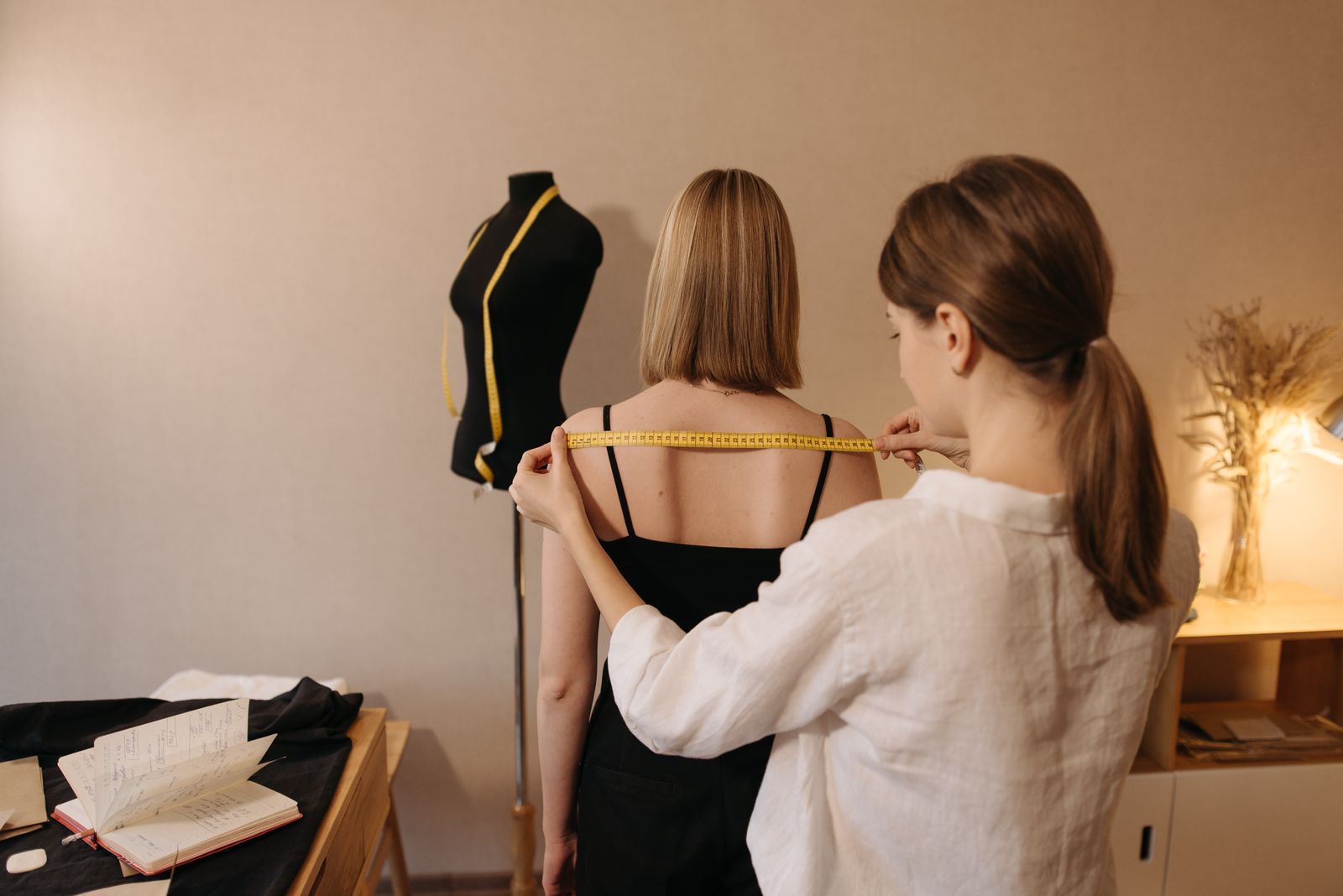 Tailor measuring a client